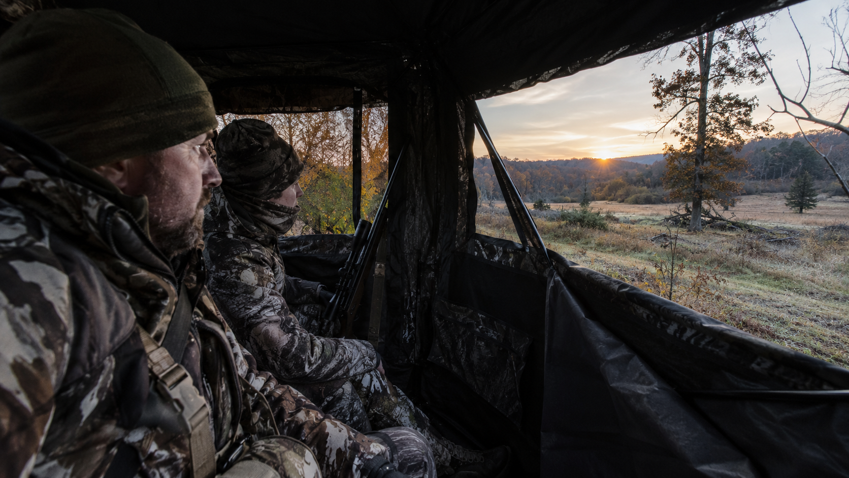 Deer hunters waiting for dawn inside an enclosed blind
